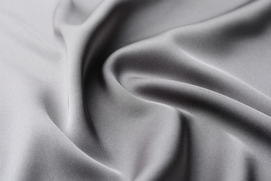 Texture of beautiful light grey silk fabric as background, closeup