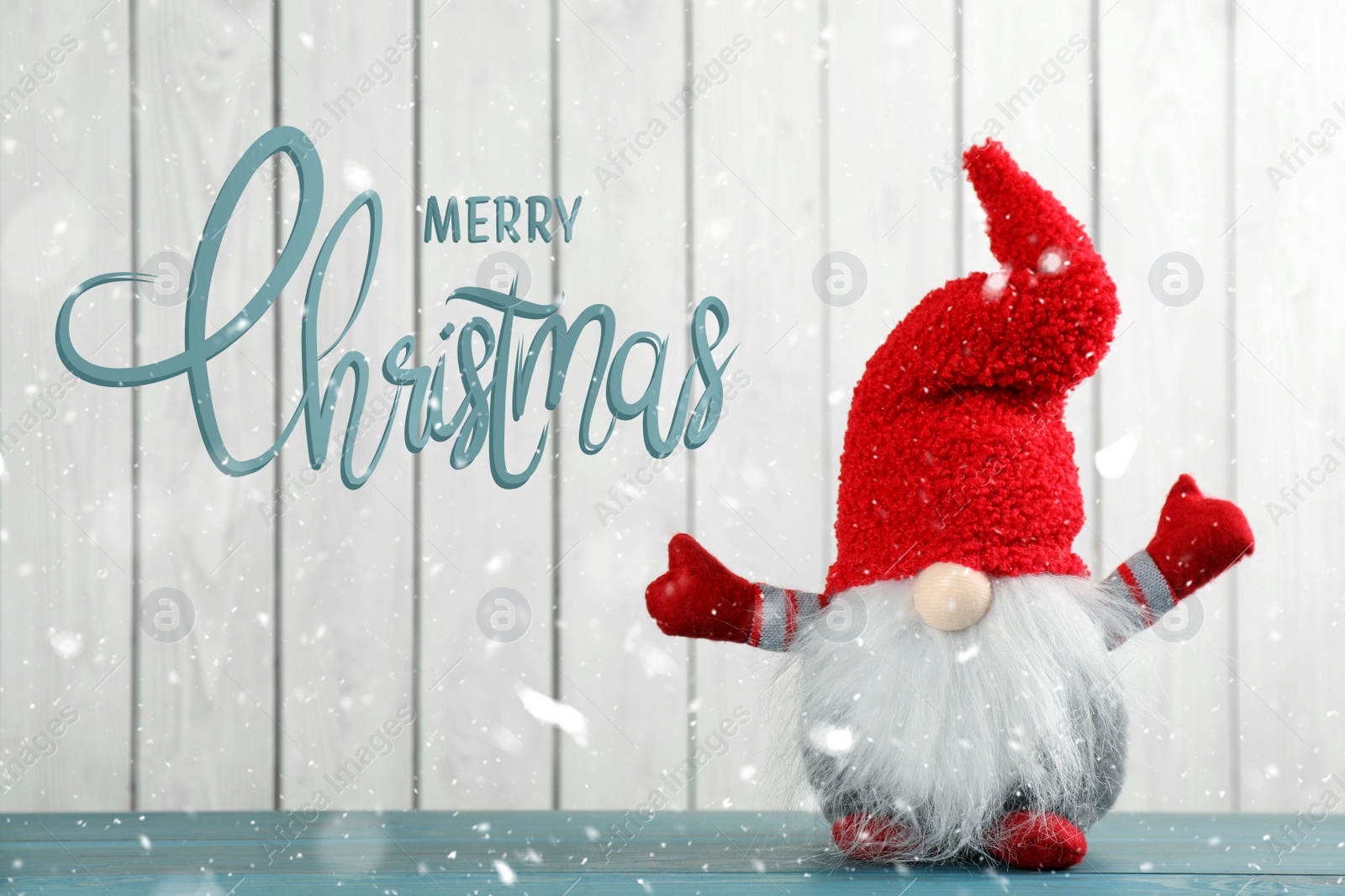 Image of Merry Christmas! Cute gnome on turquoise table against white wooden background