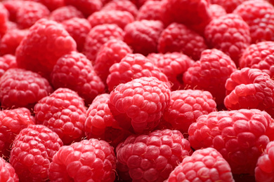 Photo of Fresh sweet ripe raspberries as background, closeup