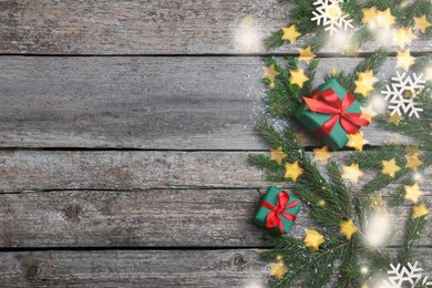 Photo of Christmas greeting card with space for text. Flat lay composition of fir tree branches and festive decor on wooden background