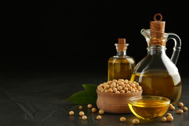 Photo of Composition with soybean oil on grey table, space for text