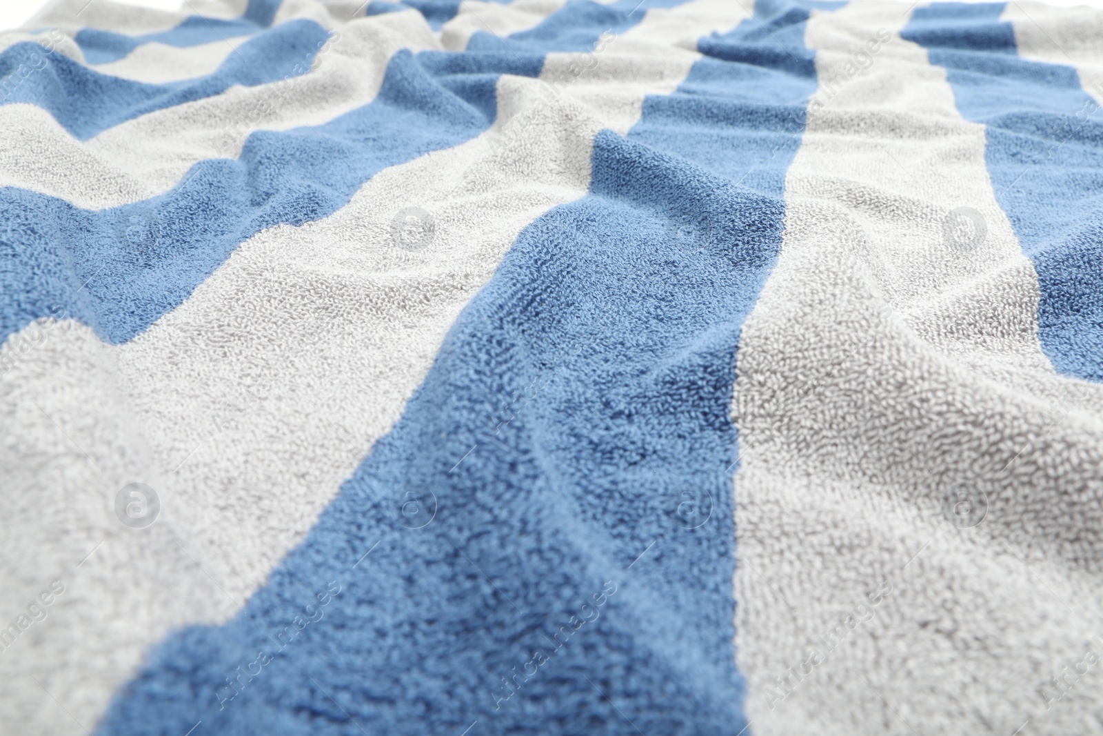 Photo of Crumpled striped beach towel as background, closeup view