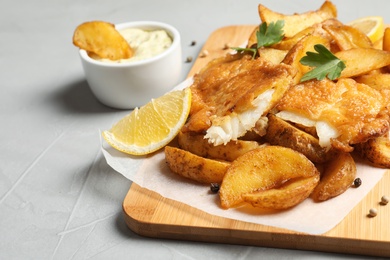 Photo of British traditional fish and potato chips on table. Space for text