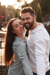 Lovely couple dancing together outdoors at sunset