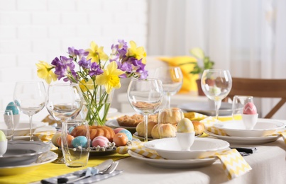 Photo of Festive Easter table setting with traditional meal at home