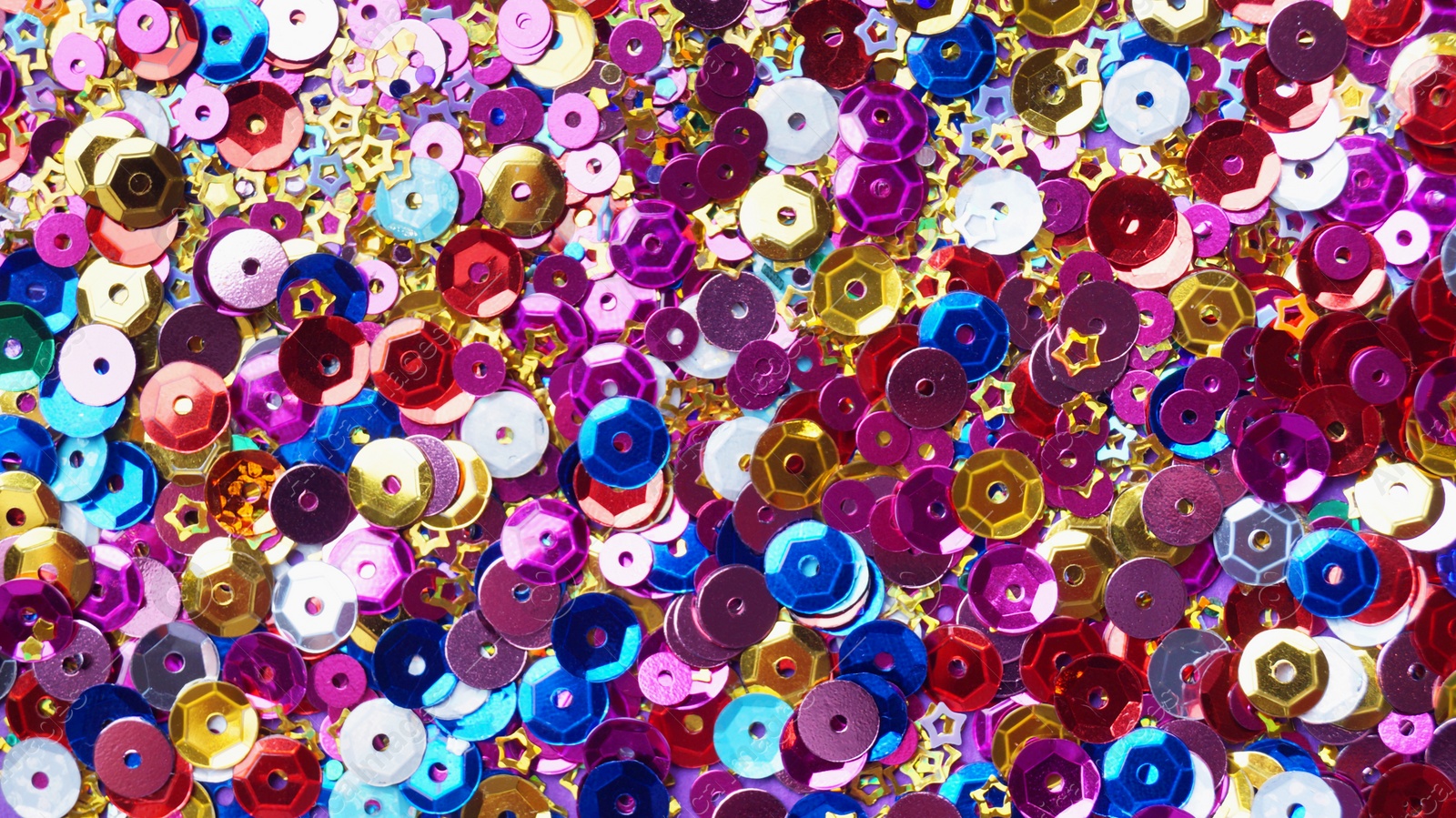 Photo of Many different colorful sequins as background, top view