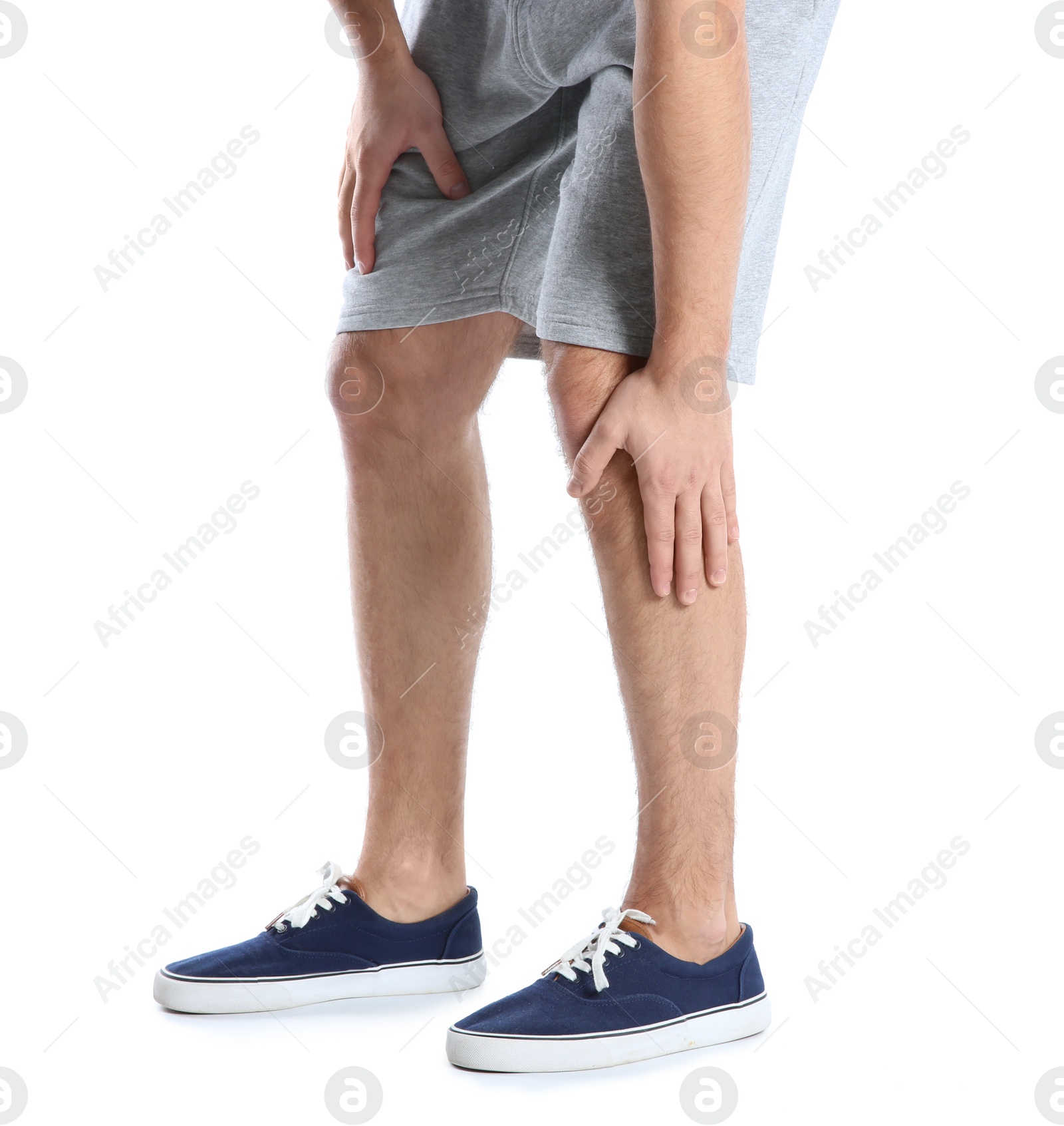 Photo of Man suffering from leg pain on white background, closeup