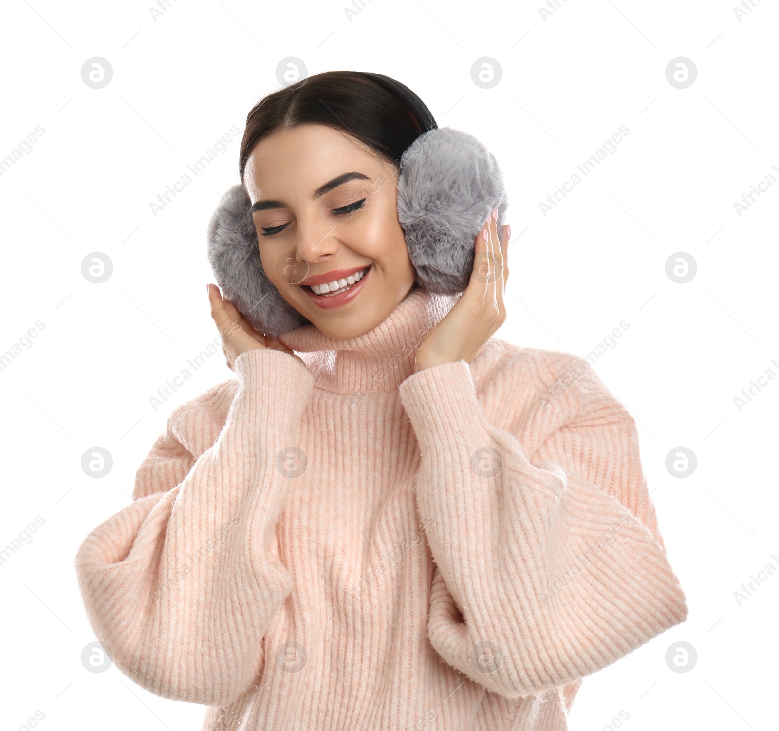 Photo of Beautiful young woman wearing earmuffs on white background