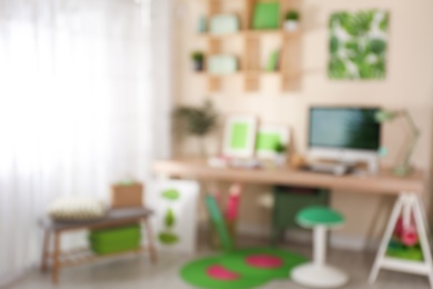 Photo of Blurred view of comfortable workplace with computer at home