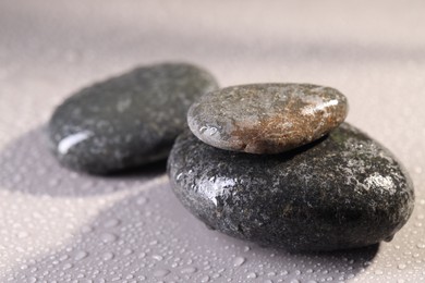 Photo of Wet spa stones on grey background, closeup