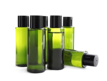 Photo of Mini bottles with cosmetic products on white background