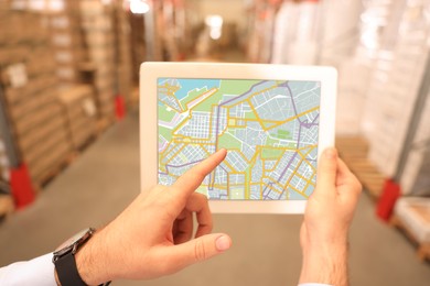 Image of Man with tablet at warehouse, closeup. Wholesale business