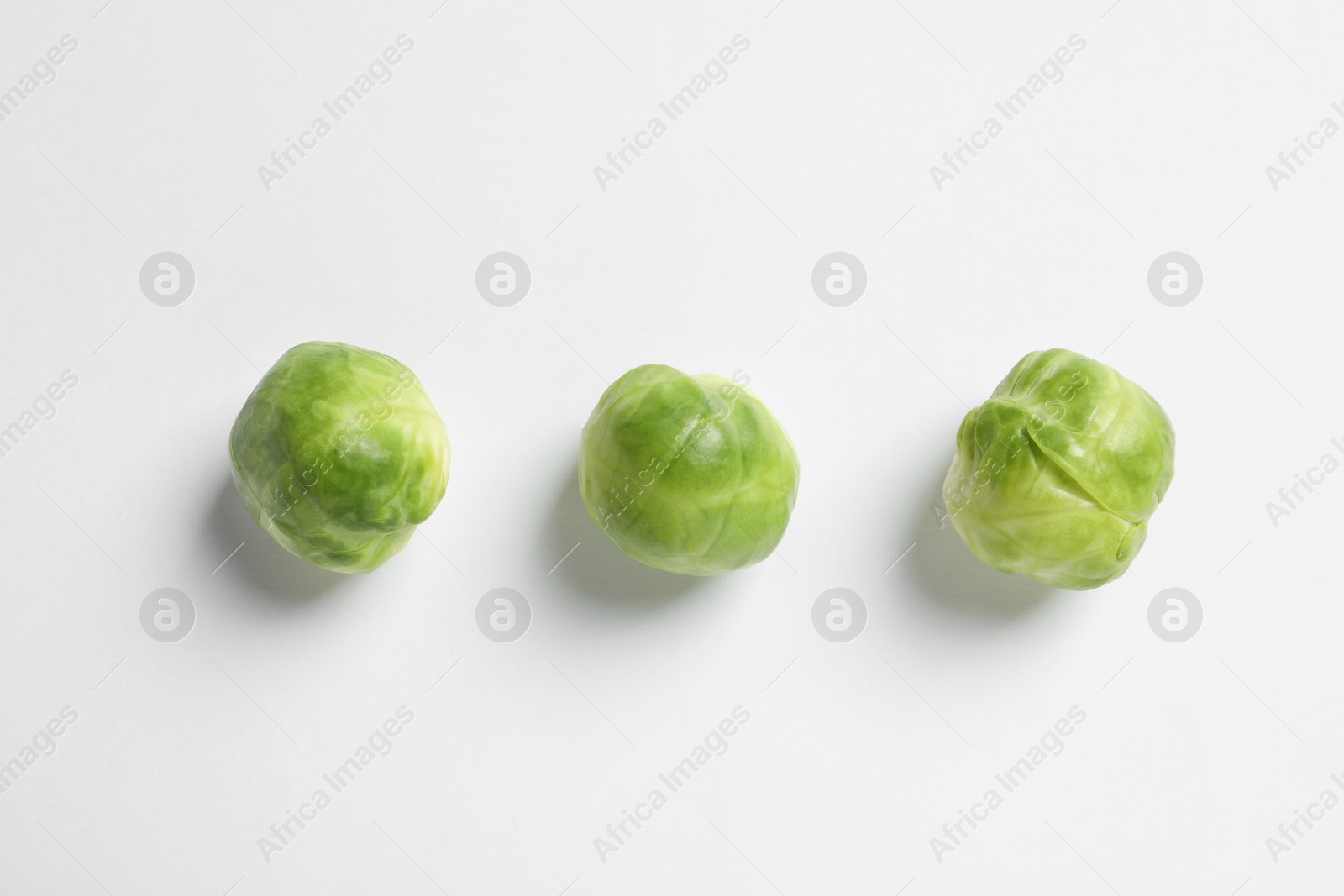 Photo of Tasty fresh Brussels sprouts on white background, top view