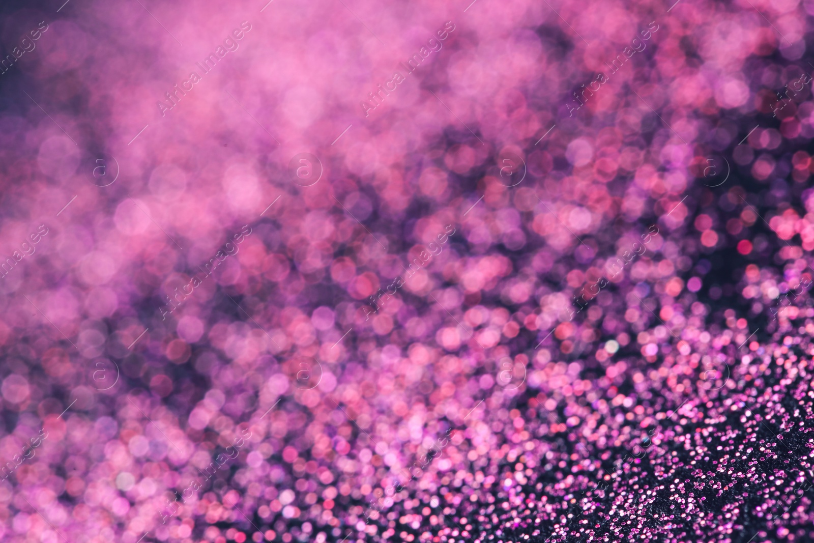 Photo of Pink glitter with bokeh effect on dark background