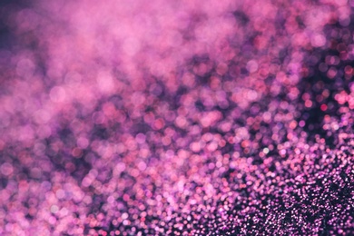 Pink glitter with bokeh effect on dark background