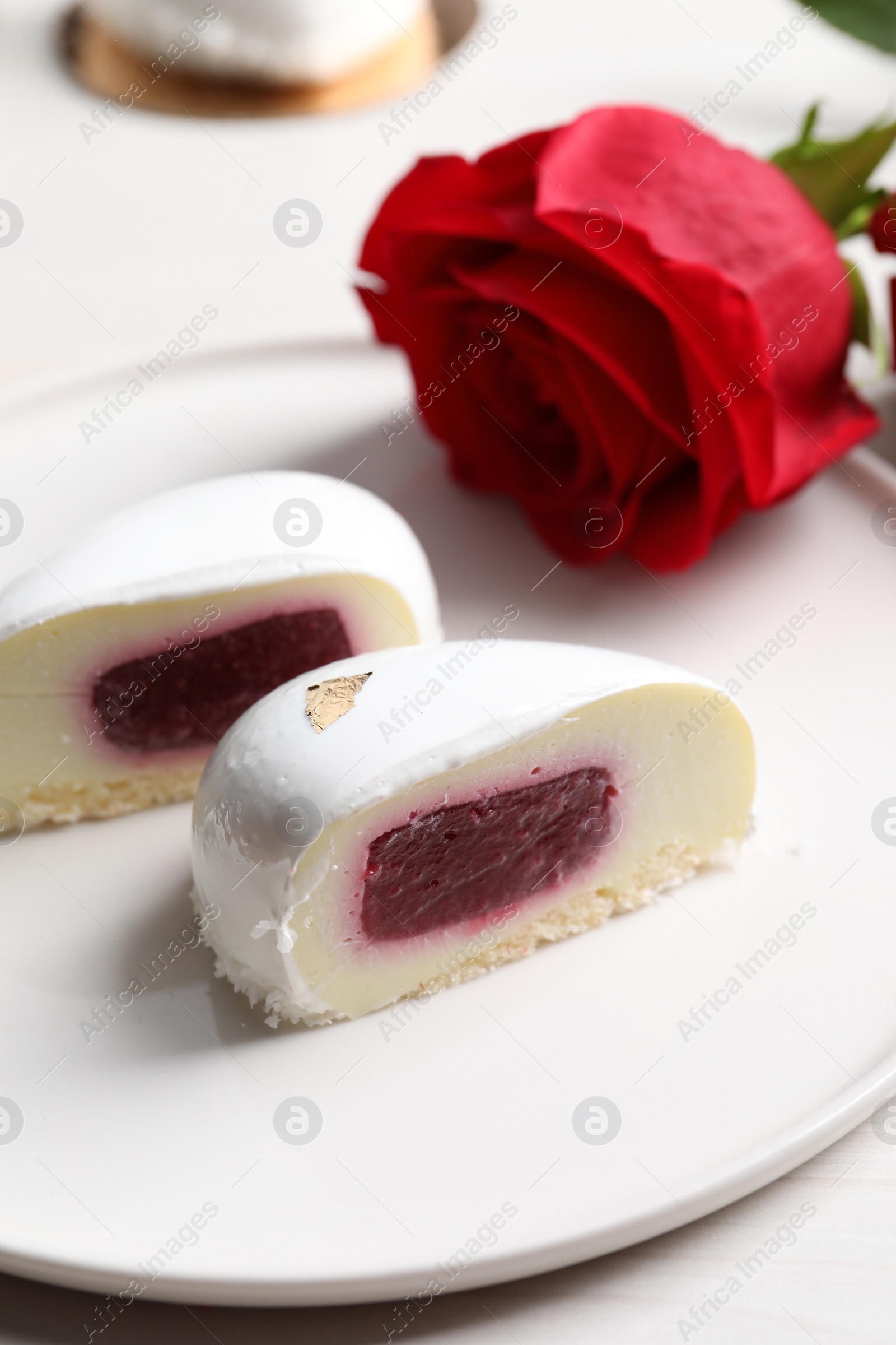 Photo of St. Valentine's Day. Pieces of delicious cake served on white table, closeup