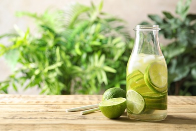 Natural lemonade with lime in bottle on table