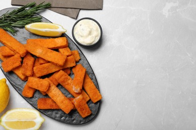 Photo of Tasty fresh fish fingers served on white table, flat lay. Space for text