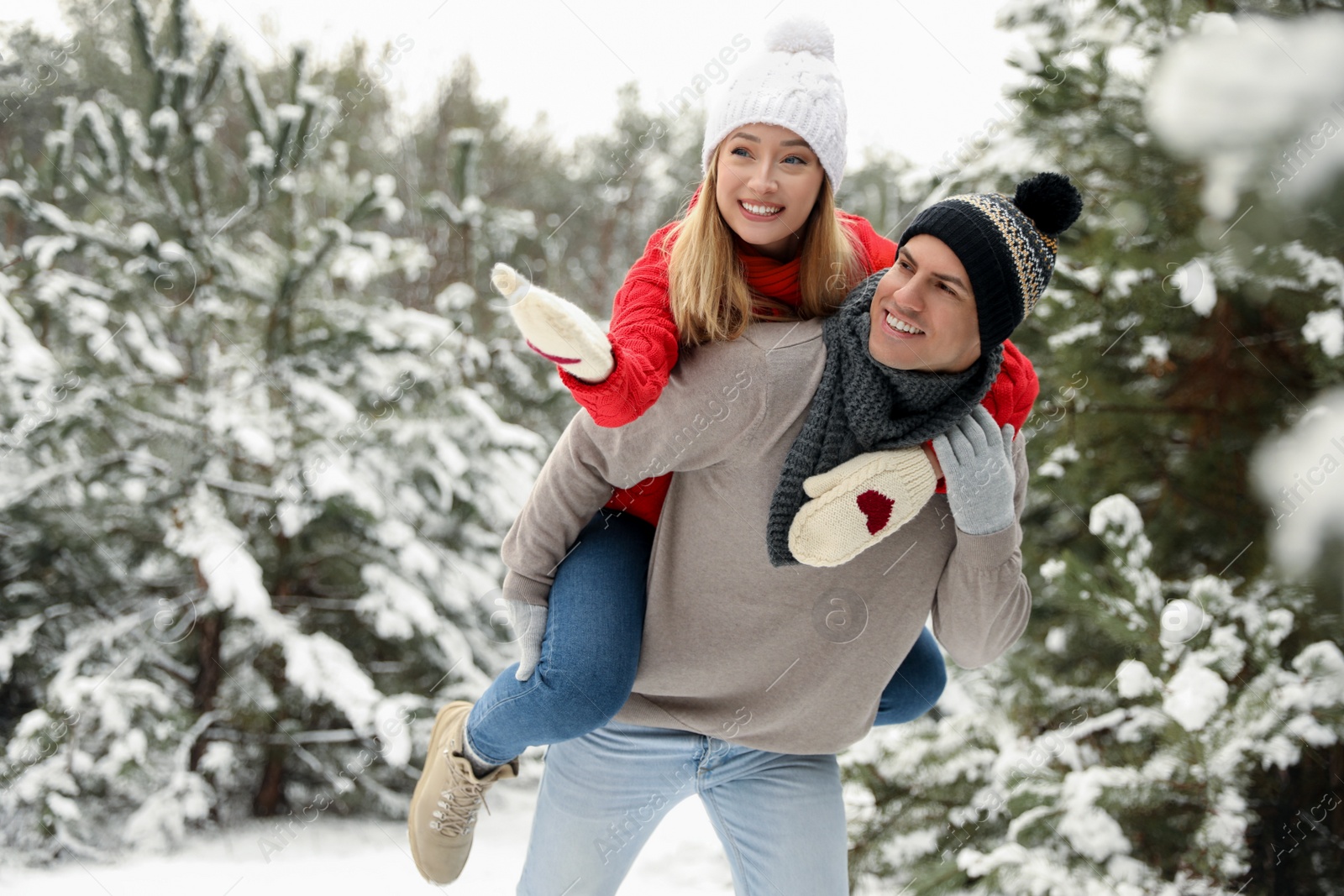 Photo of Beautiful happy couple in snowy forest on winter day