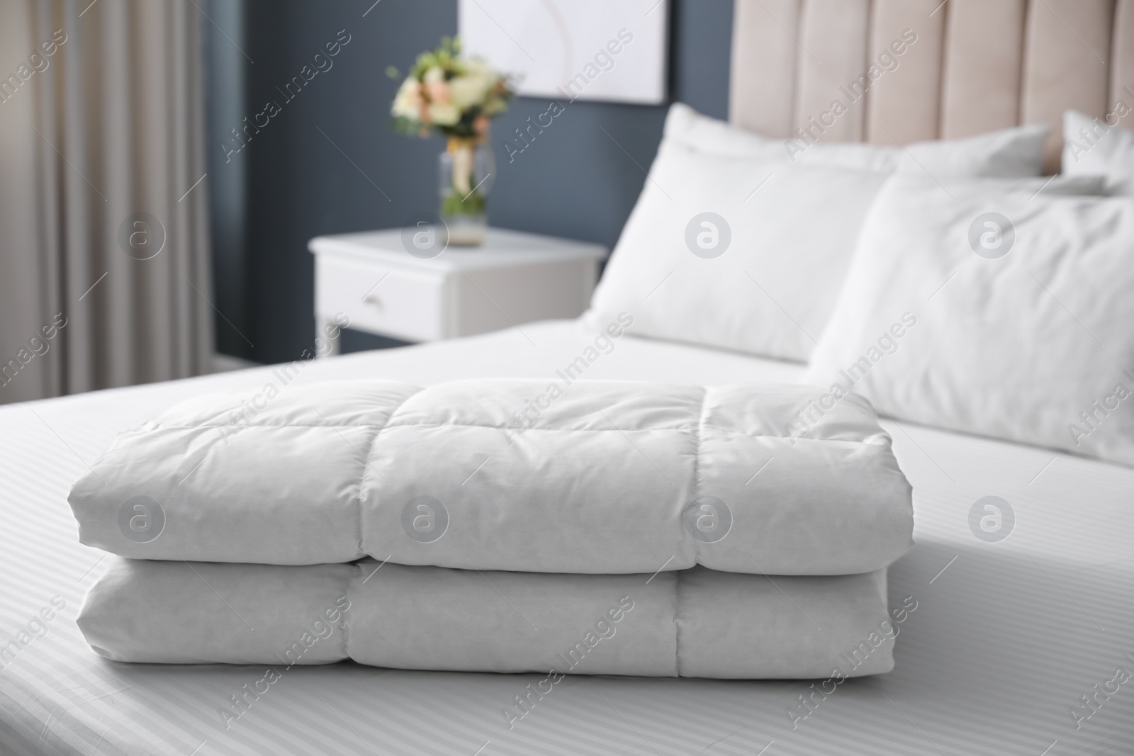 Photo of Soft folded blanket on bed at home