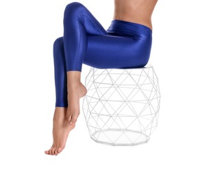 Photo of Woman with beautiful long legs wearing blue leggings on white background, closeup