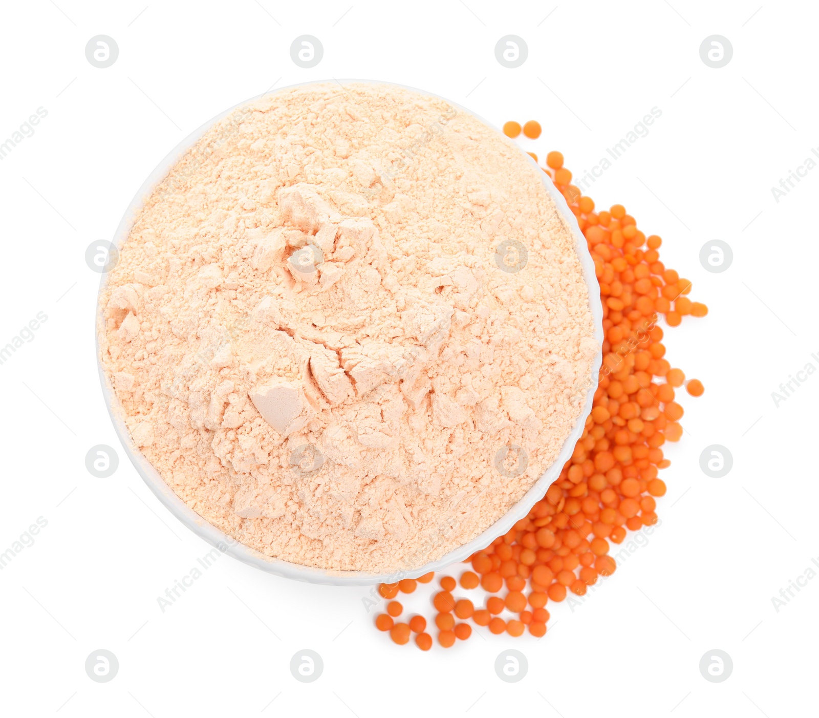 Photo of Bowl with lentil flour and grains on white background, top view