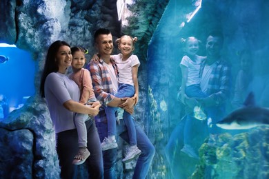 Image of Happy family near aquarium in oceanarium. Spending time together