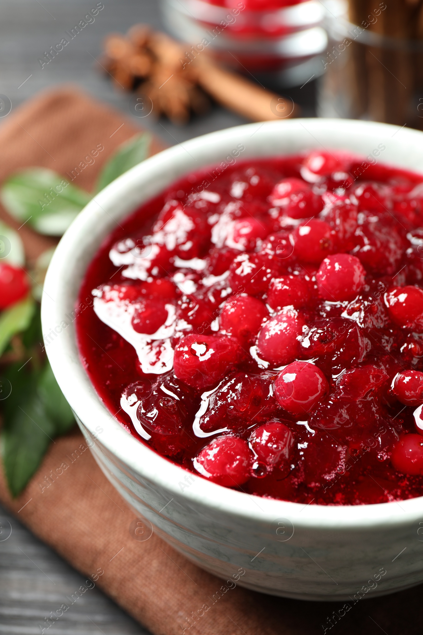 Photo of Delicious fresh cranberry sauce in bowl, closeup