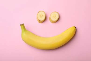 Funny flat lay composition with bananas on color background