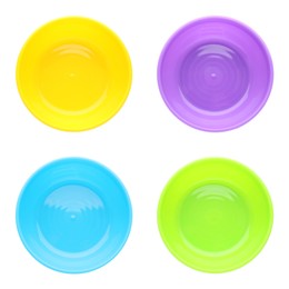 Image of Set with colorful plastic plates on white background, top view. Serving baby food