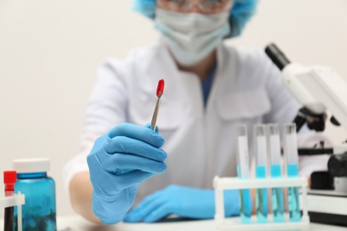 Photo of Scientist working in laboratory, focus on pill