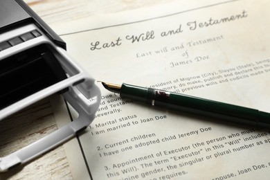 Last Will and Testament, stamp and pen on white wooden table, closeup