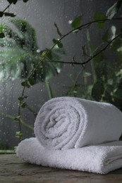 Photo of White terry towels on table in bathroom