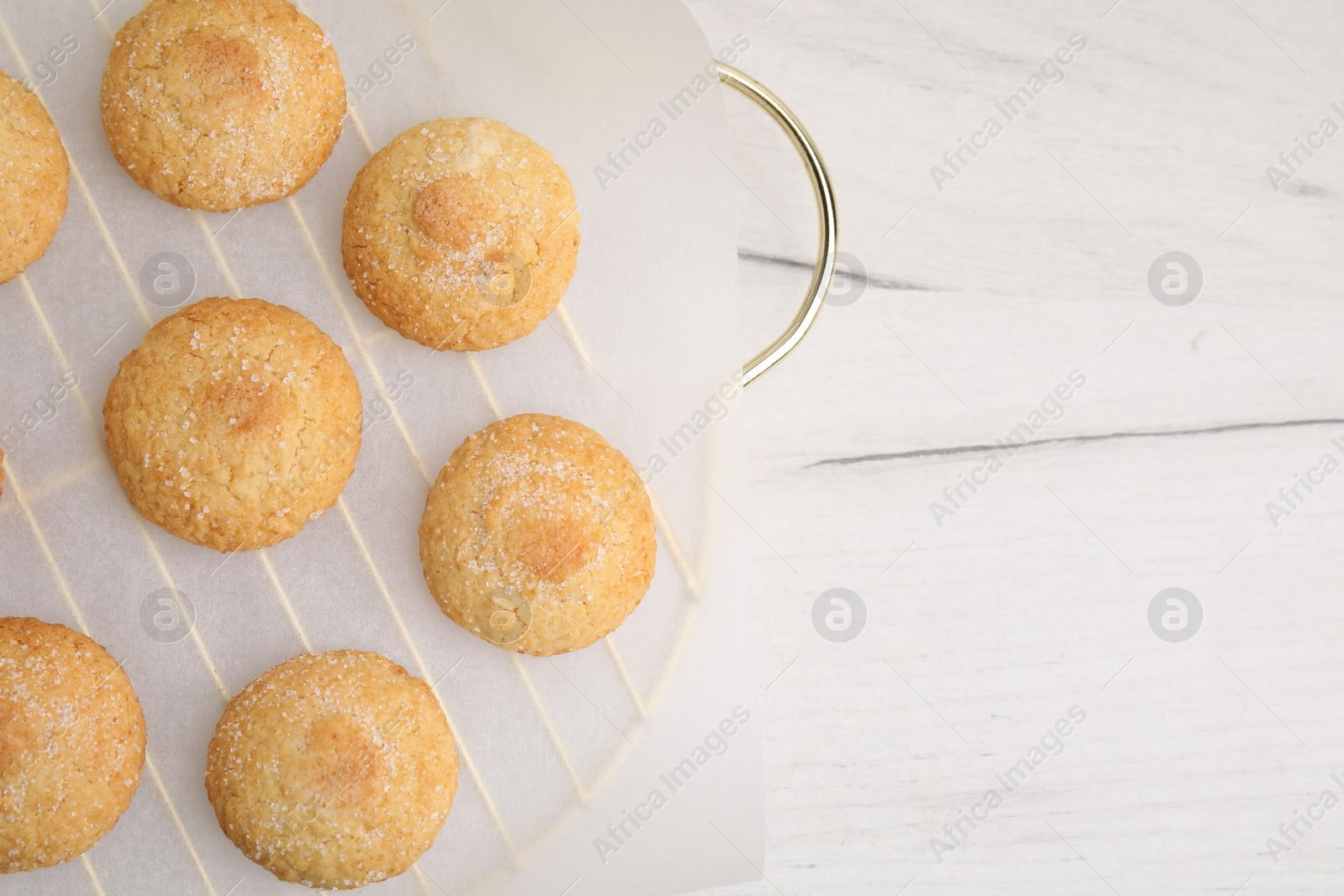 Photo of Tasty sweet sugar cookies on white wooden table, top view. Space for text