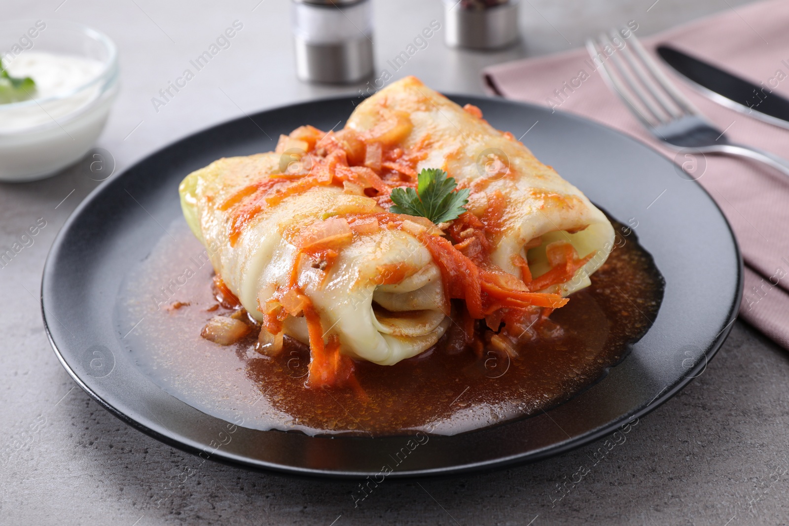 Photo of Delicious cabbage rolls served on grey table, closeup