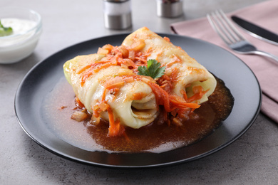 Photo of Delicious cabbage rolls served on grey table, closeup