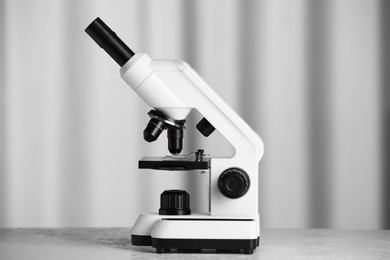 Photo of Modern microscope on table indoors. Medical equipment