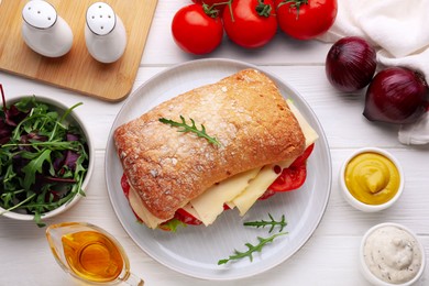 Photo of Delicious sandwich with tasty filling and ingredients on white wooden table, flat lay