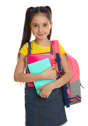 Little girl with school stationery on white background