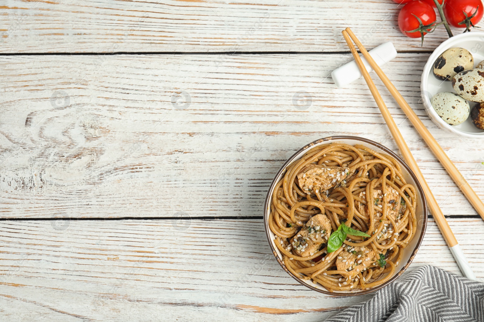 Photo of Tasty buckwheat noodles with meat served on white wooden table, flat lay. Space for text