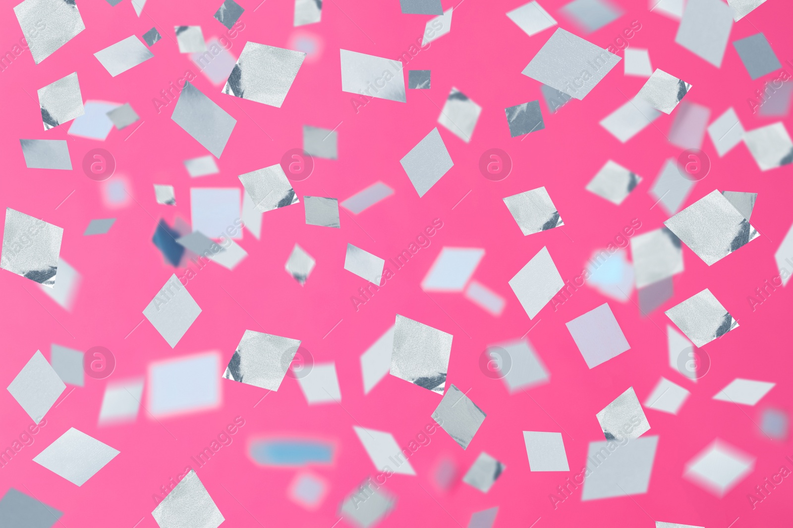 Image of Shiny confetti falling down on pink background