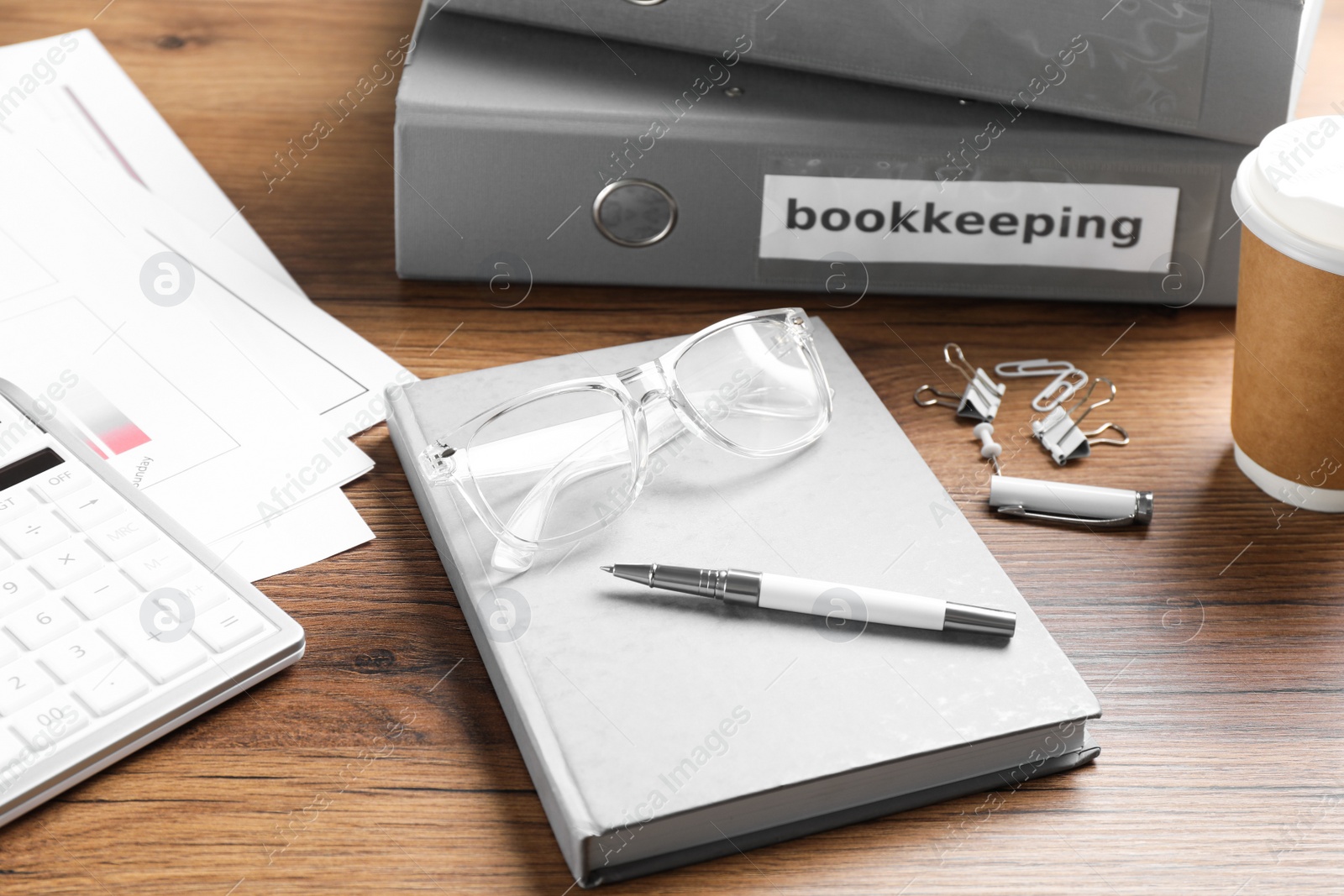 Photo of Bookkeeper's workplace with folders and documents on table