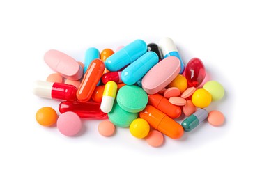 Photo of Pile of different colorful pills on white background, above view