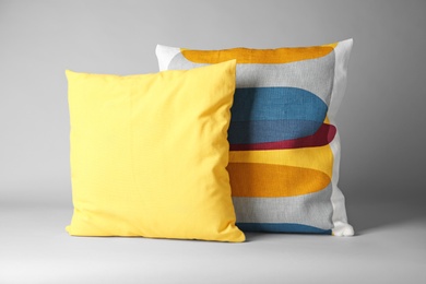 Photo of Soft decorative pillows on light background