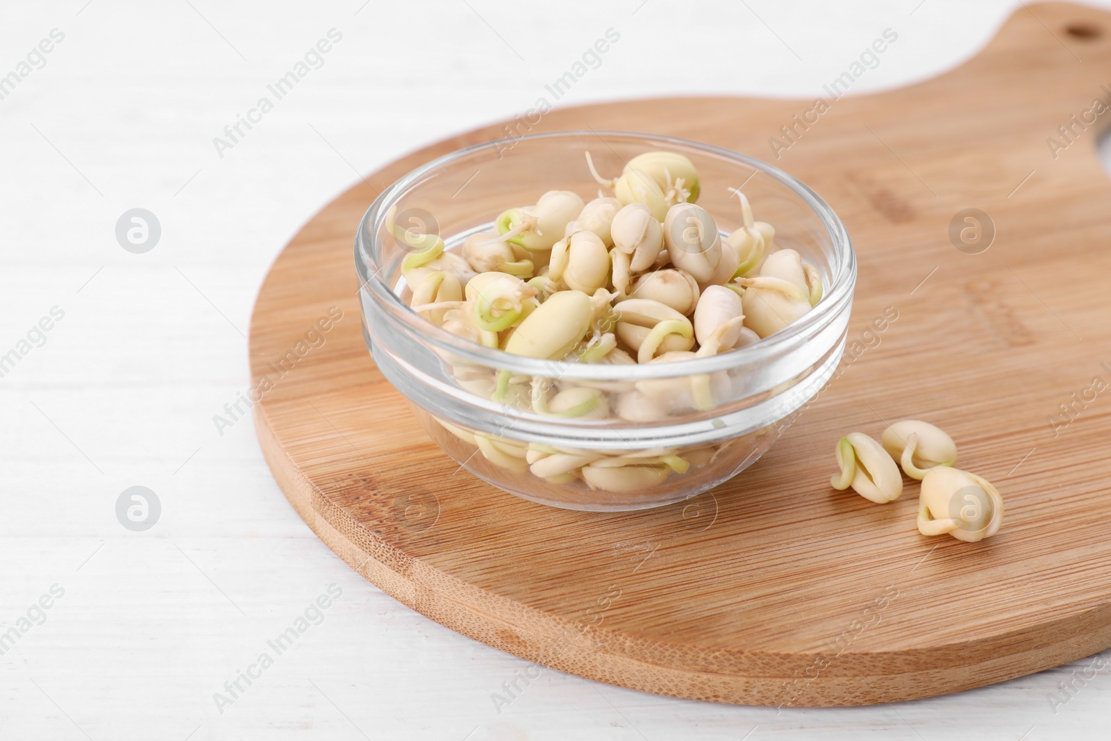 Photo of Sprouted kidney beans on white wooden table, closeup