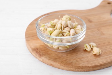 Photo of Sprouted kidney beans on white wooden table, closeup
