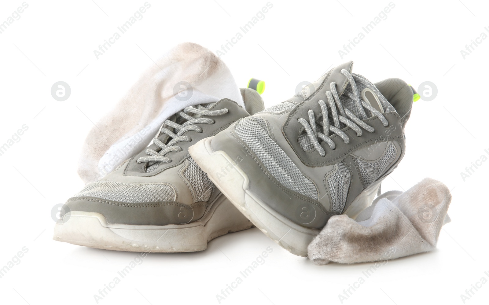 Photo of Sneakers with dirty socks on white background