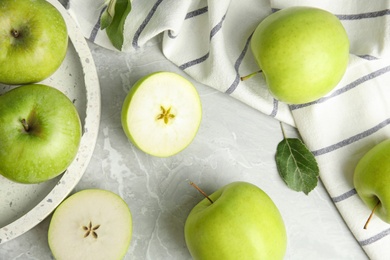 Photo of Flat lay composition of fresh ripe green apples on grey stone table