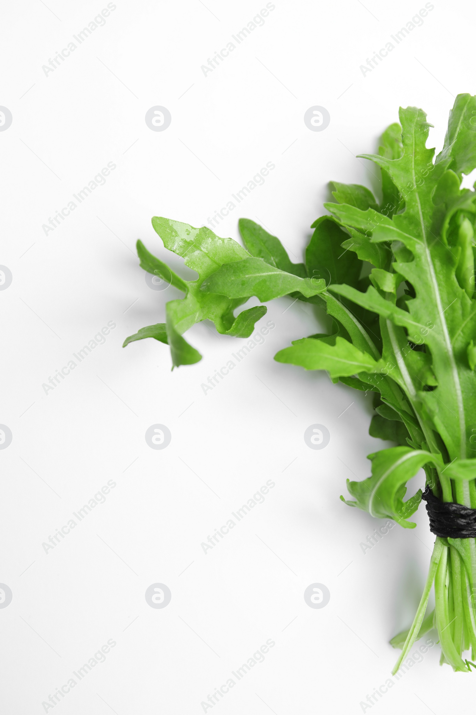 Photo of Fresh arugula on white background, top view