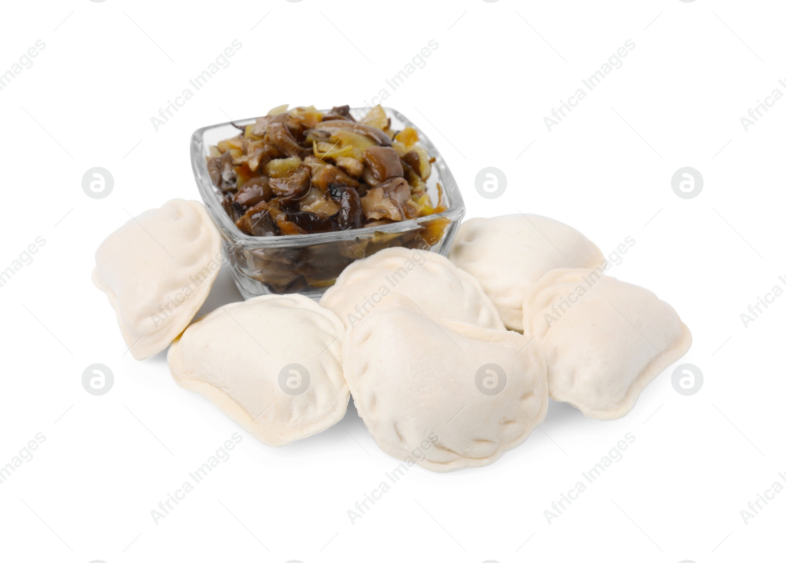 Photo of Raw dumplings (varenyky) and cooked mushrooms isolated on white